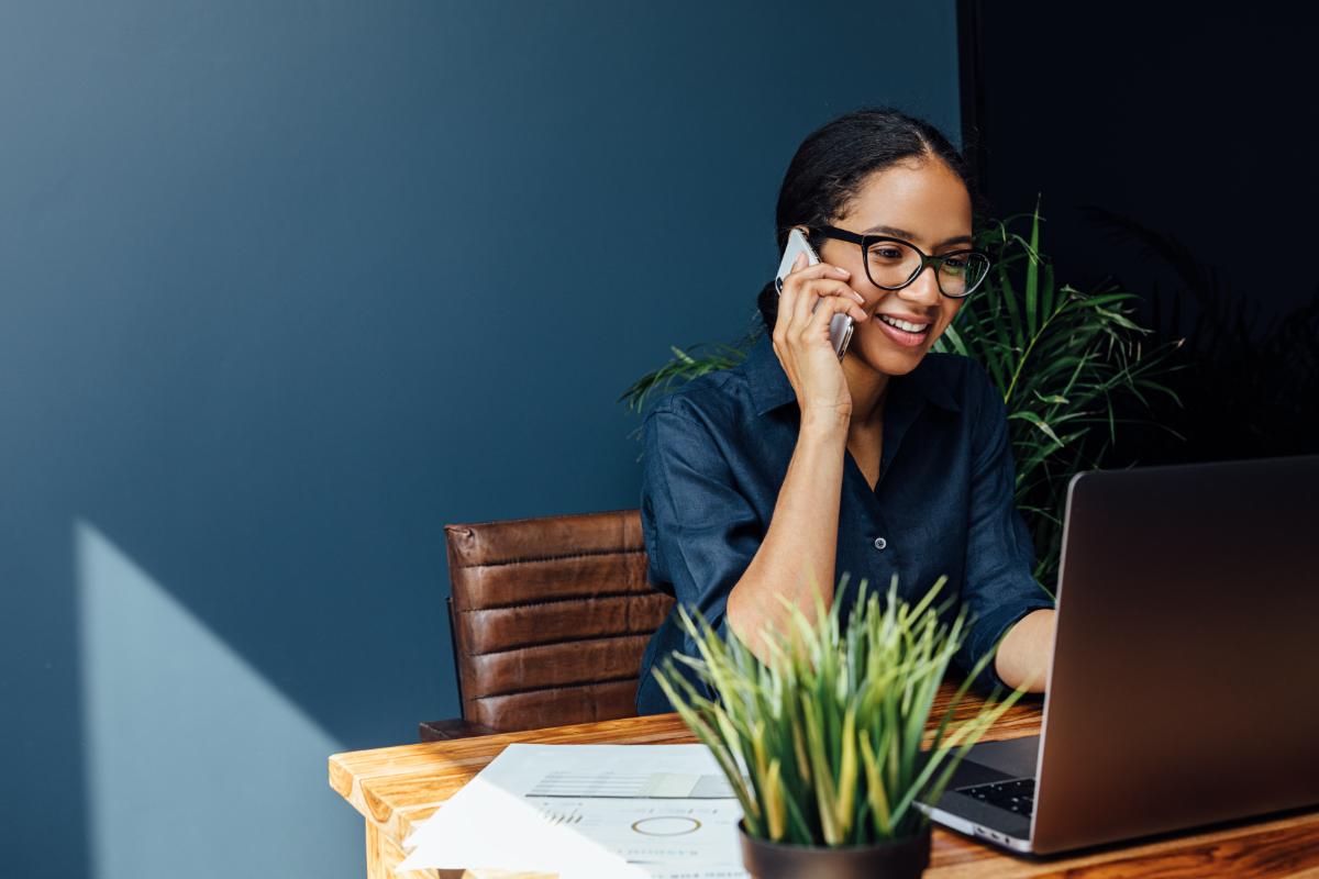 a woman browses job listings for telehealth jobs in behavioral health