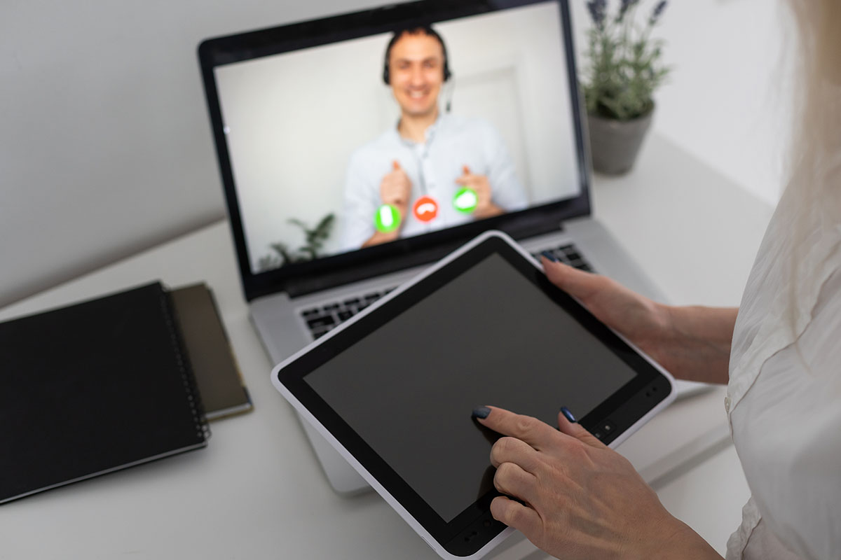 a person works on a computer for a telehealth mental health job