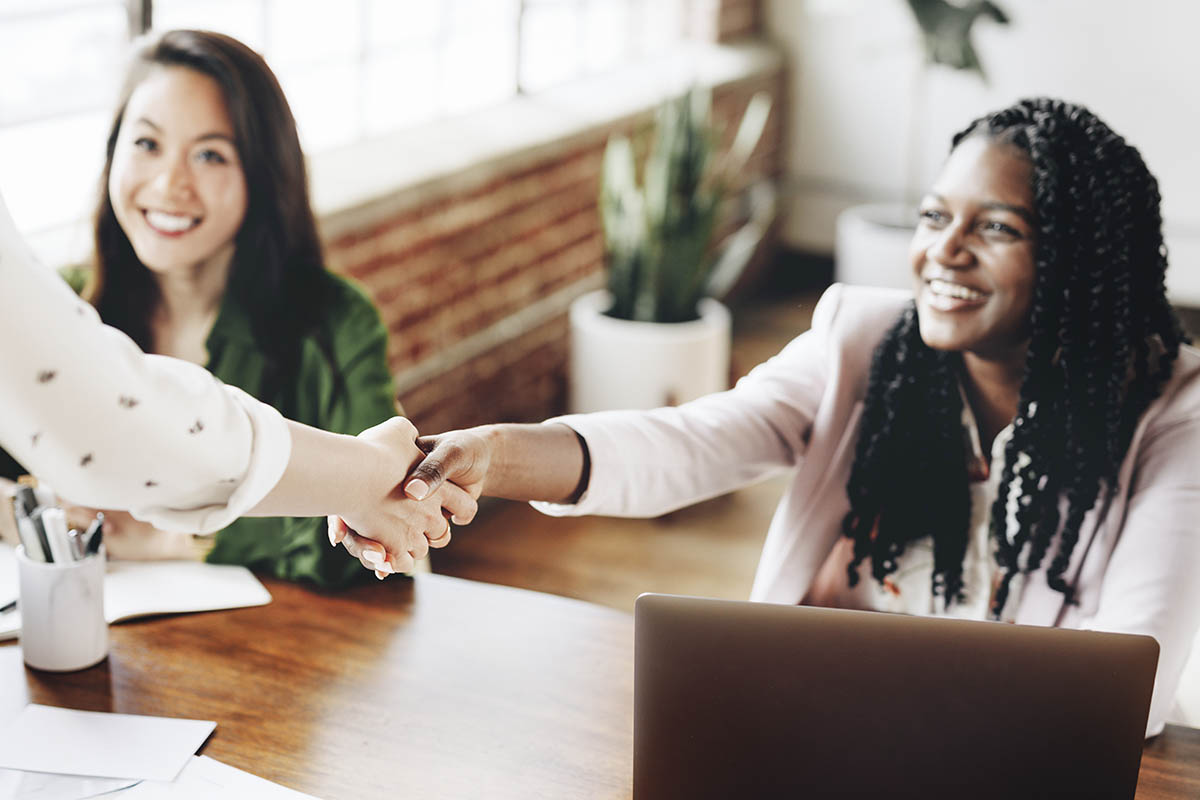 two people shake hands in front of another as they find behavioral health jobs in philadelphia