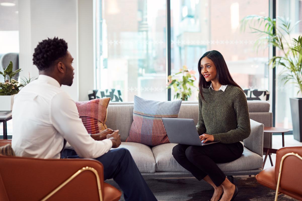 a person sits on a couch speaking with a therapist in a chair who possibly found clinical mental health counseling jobs