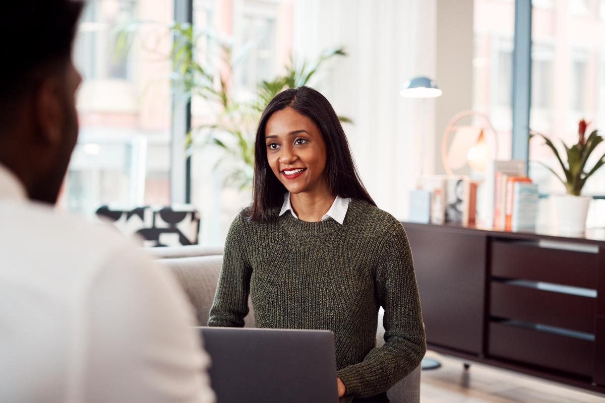 a person sits behind a computer in an interview for one of many entry level behavioral health jobs