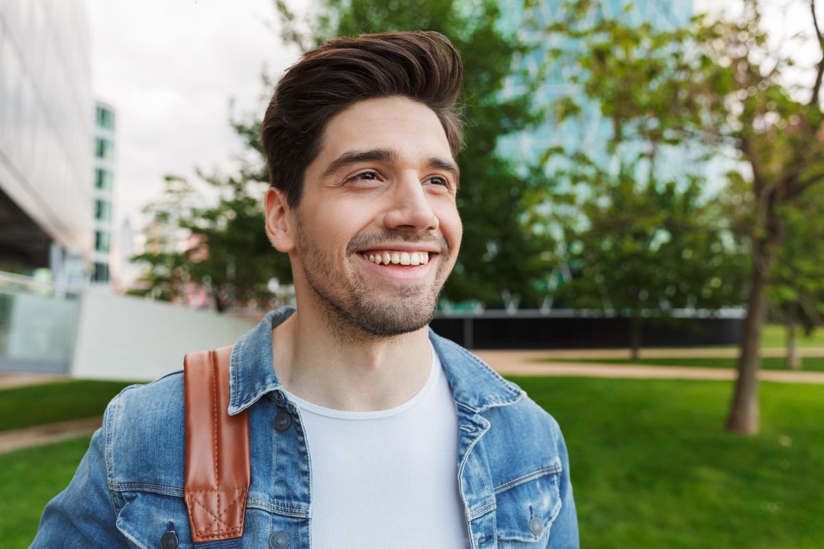 a person smiles past the camera possibly after finding jobs in social work