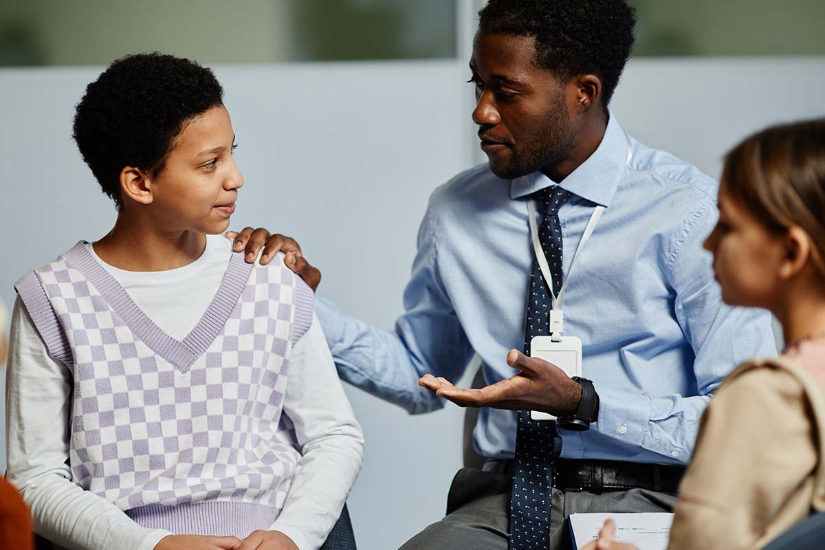 a mental health social worker comforts a child