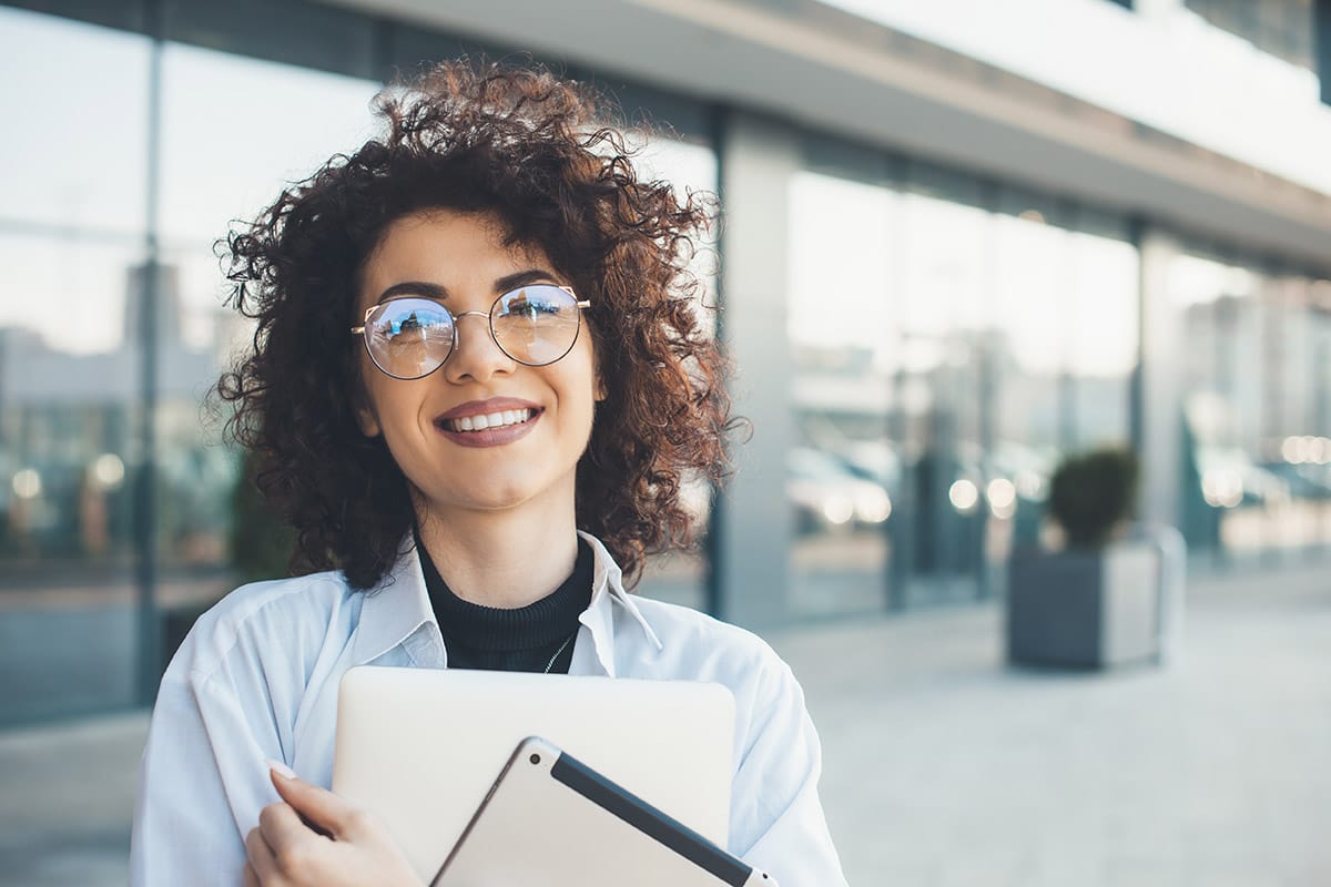 a person smiles as they enjoy the responsibilities of a social worker