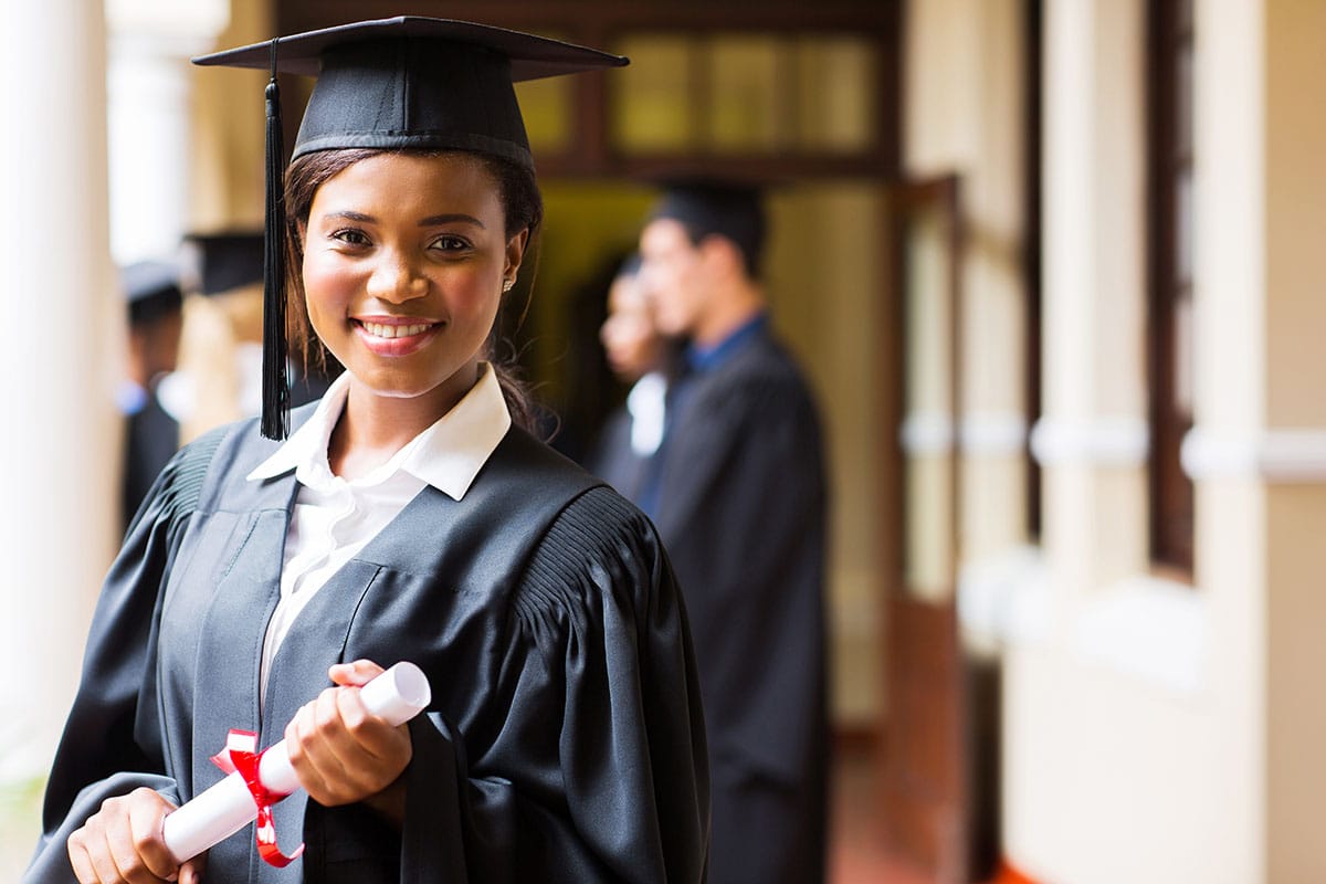 a graduate smiles after completing education requirements for a therapist