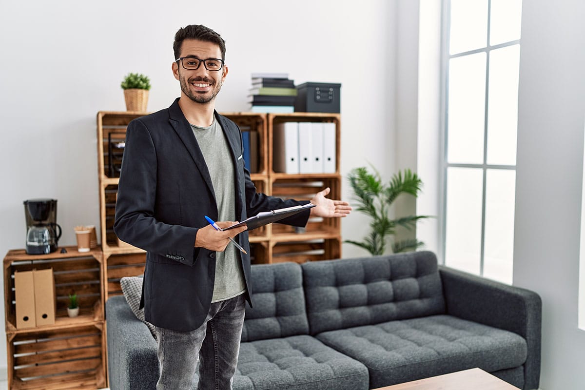 a person with one of many entry level mental health jobs holds a tablet in an office