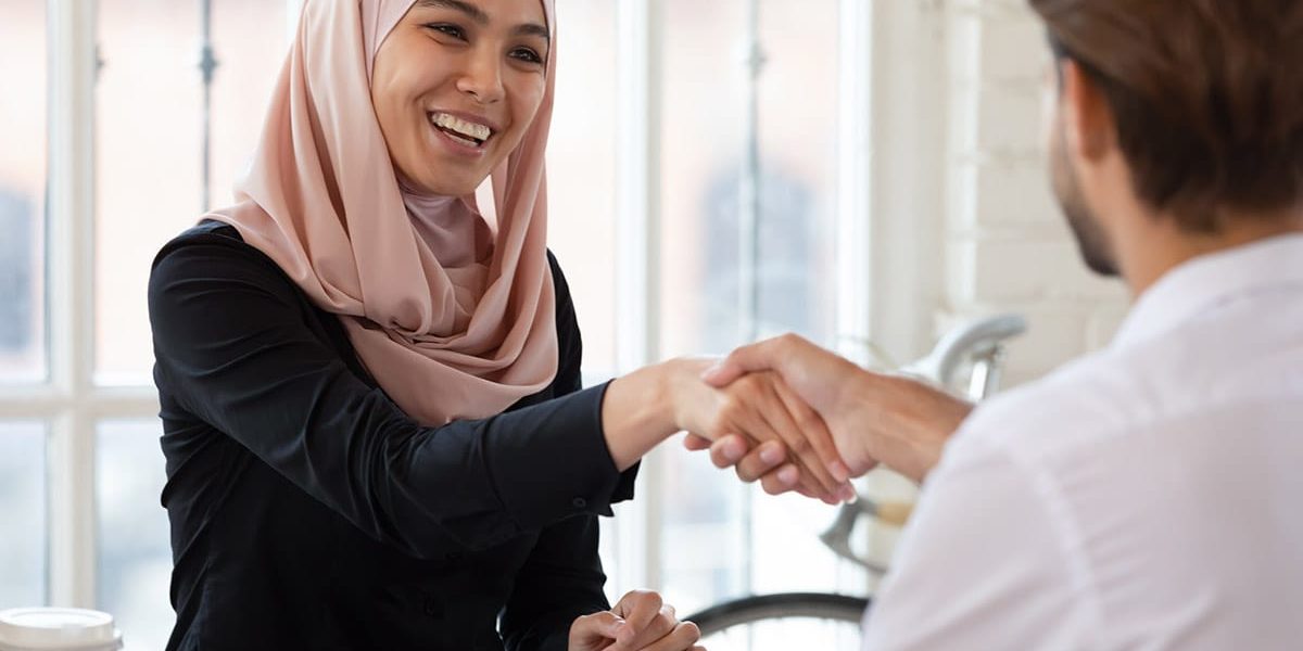 a person uses tips for negotiating salary as they shake hands with an employer