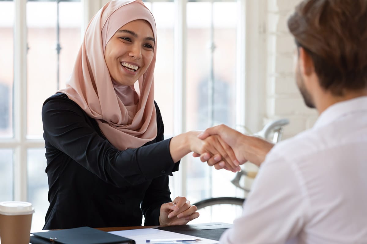 a person uses tips for negotiating salary as they shake hands with an employer