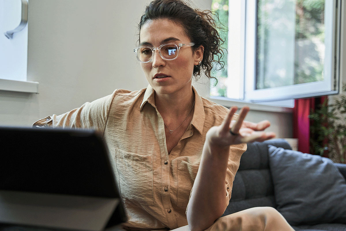 a woman works comfortably from home at her remote behavioral health job