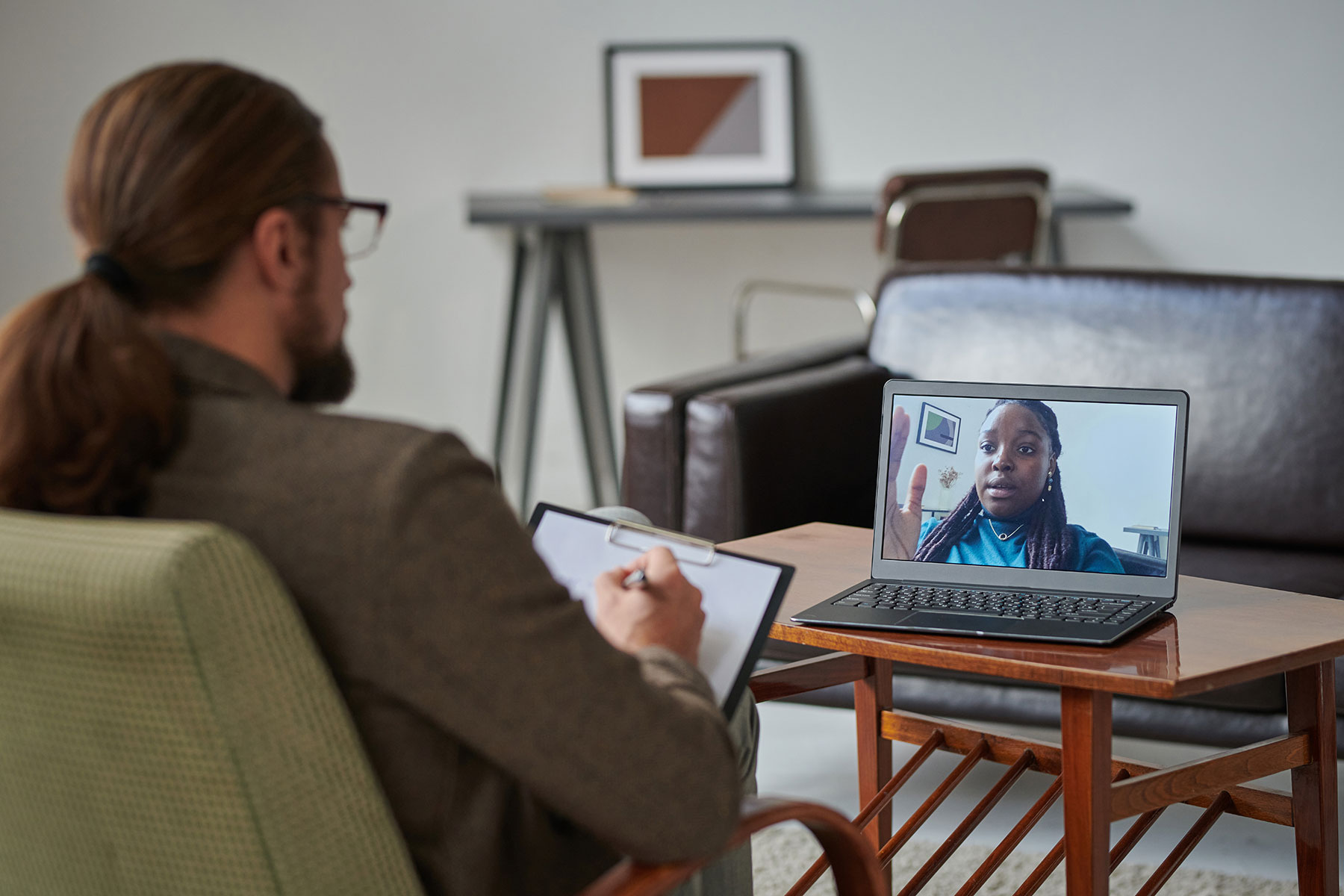 a man enjoys his remote telehealth job