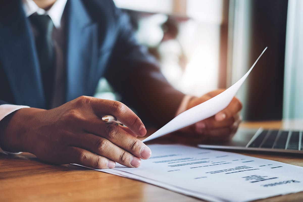 a person files through notes on a desk to avoid common resume mistakes