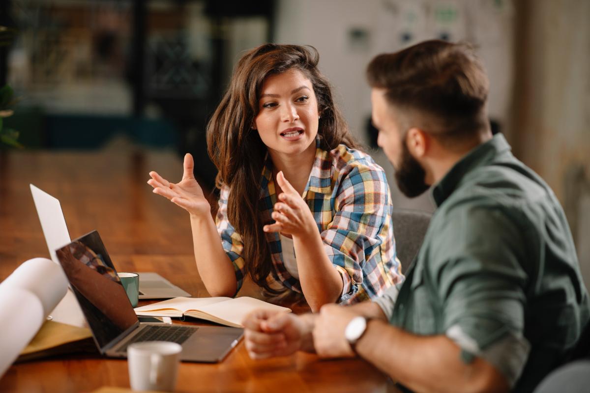 a woman explains to a friend the process of becoming a program manager