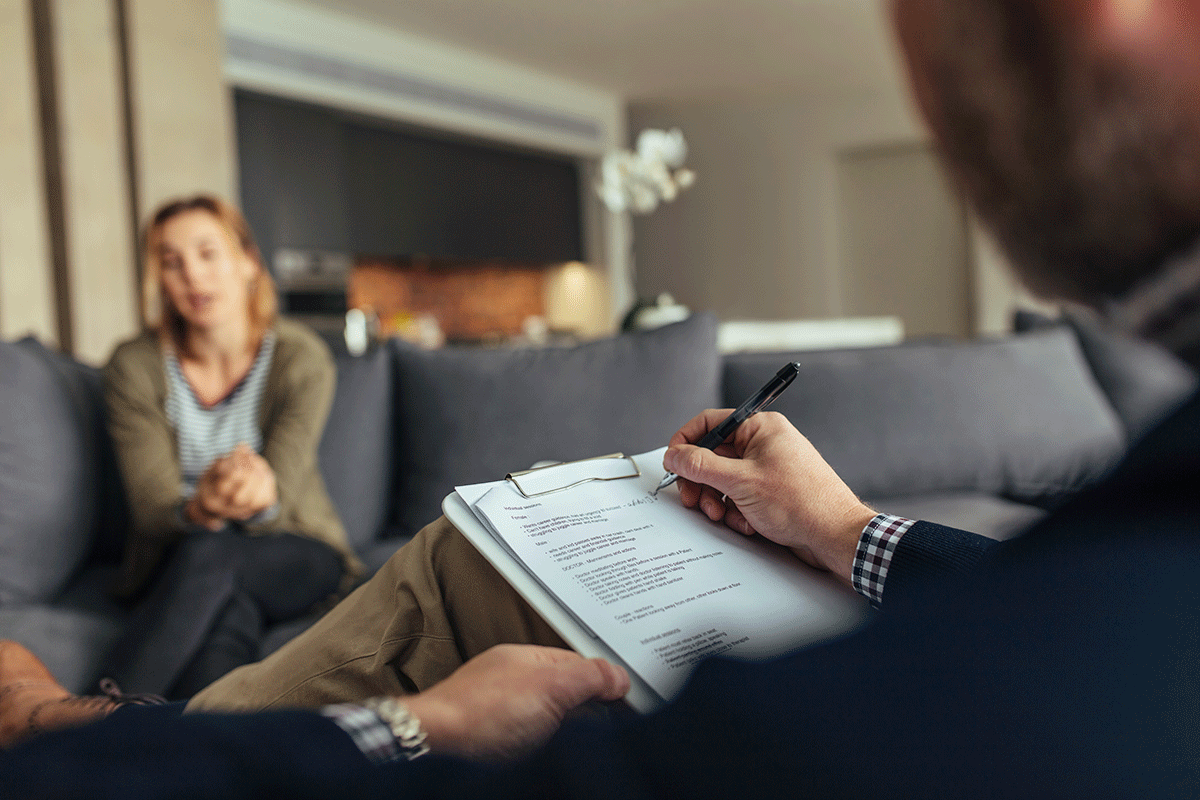 a crisis intervention specialists takes notes while working with a client