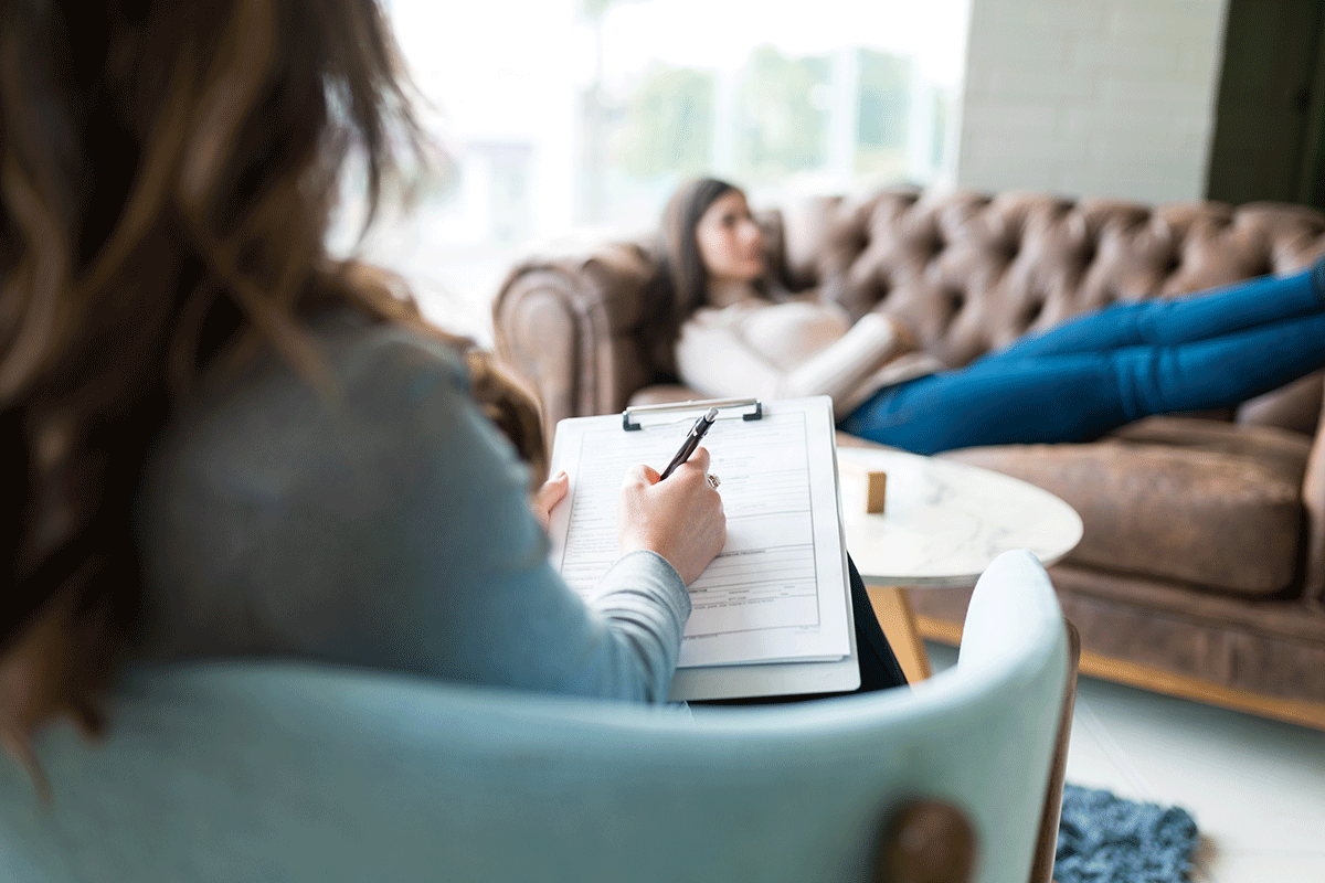 a counselor listens to a client during a session