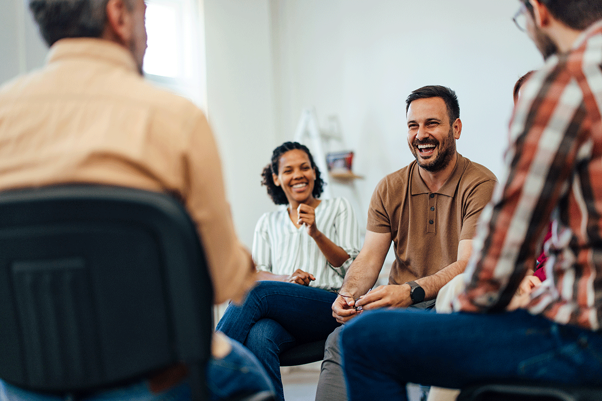 a recovery rehabilitation specialists conducts a group therapy session with clients