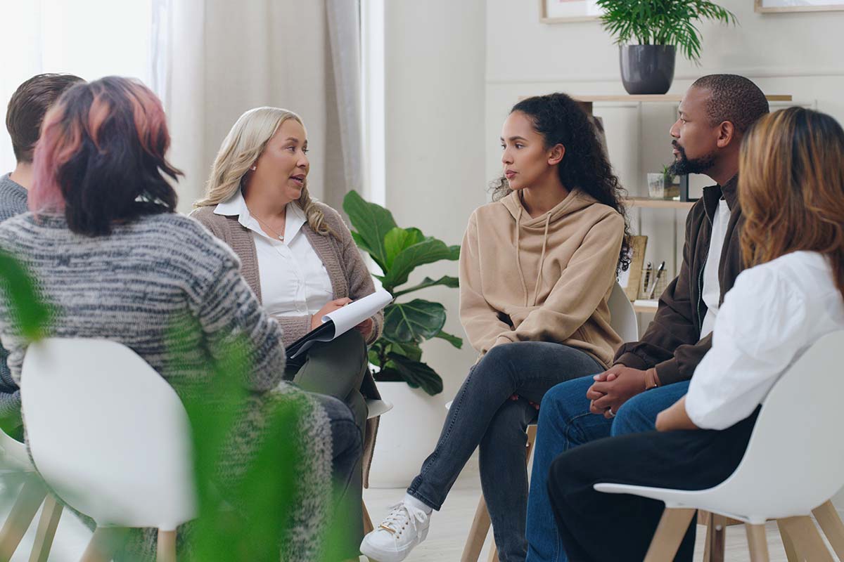 a woman enjoys working at an inpatient institution as a group therapist