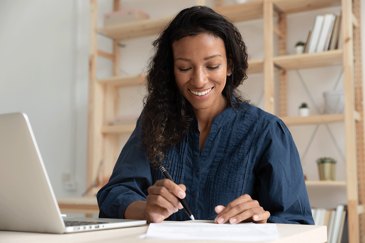 a support specialist updates notes in her office