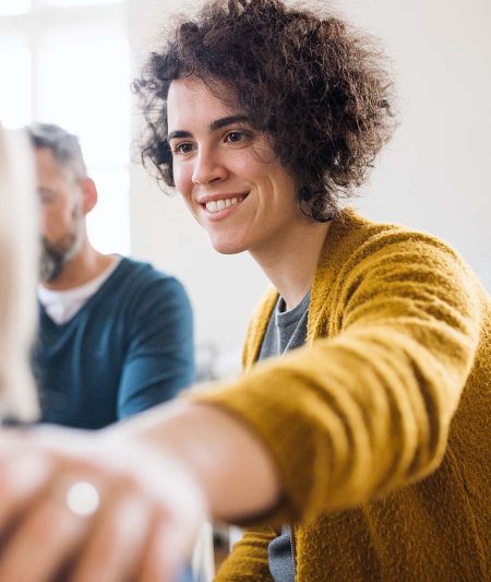 behavioral health counselor comforting someone in group therapy